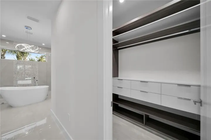 Bathroom featuring a bathtub and a chandelier