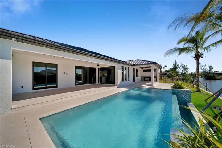 View of swimming pool with a patio area and a water view