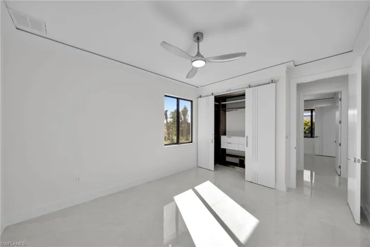 Unfurnished bedroom featuring ceiling fan and a closet