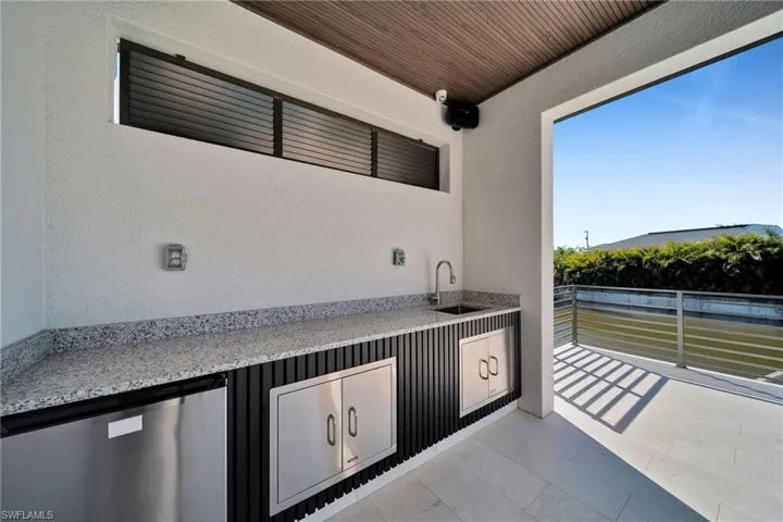 View of patio / terrace with sink and a balcony