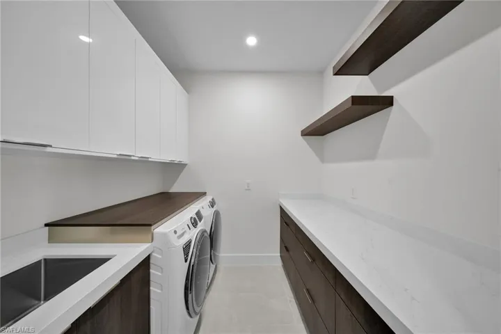 Laundry room with cabinets and independent washer and dryer
