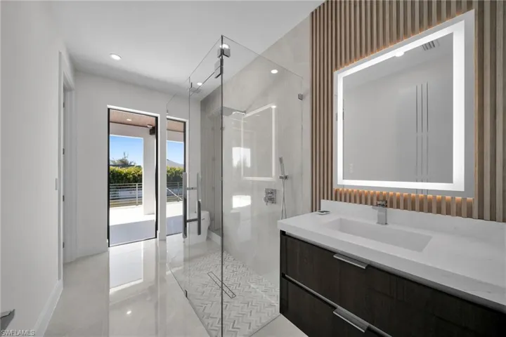 Bathroom featuring vanity and a shower with shower door