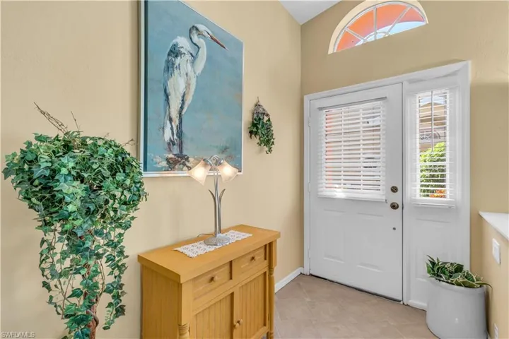 Foyer entrance featuring light tile patterned flooring
