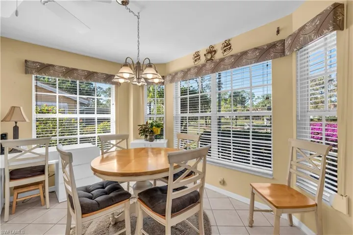 Tiled dining room with a notable chandelier