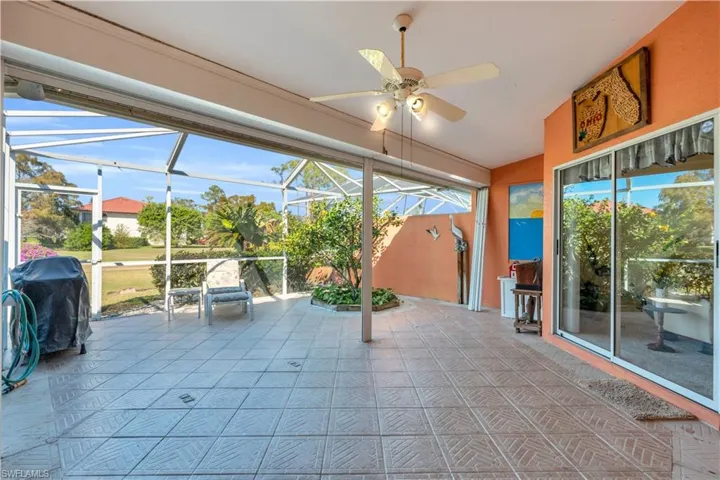 Unfurnished sunroom with ceiling fan and lofted ceiling