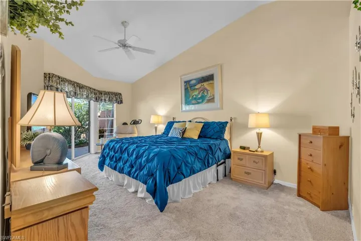 Bedroom with light carpet, access to outside, ceiling fan, and lofted ceiling