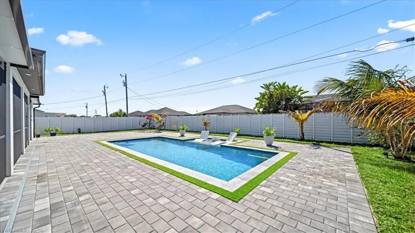 View of swimming pool featuring patio surround and a fenced backyard