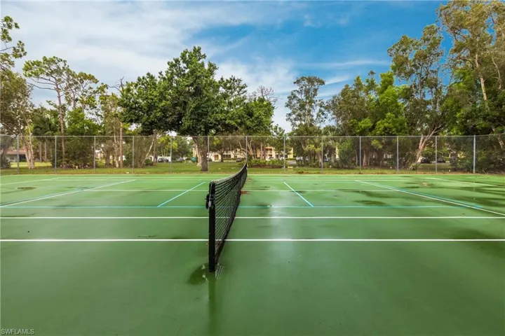 View of tennis court with community basketball court