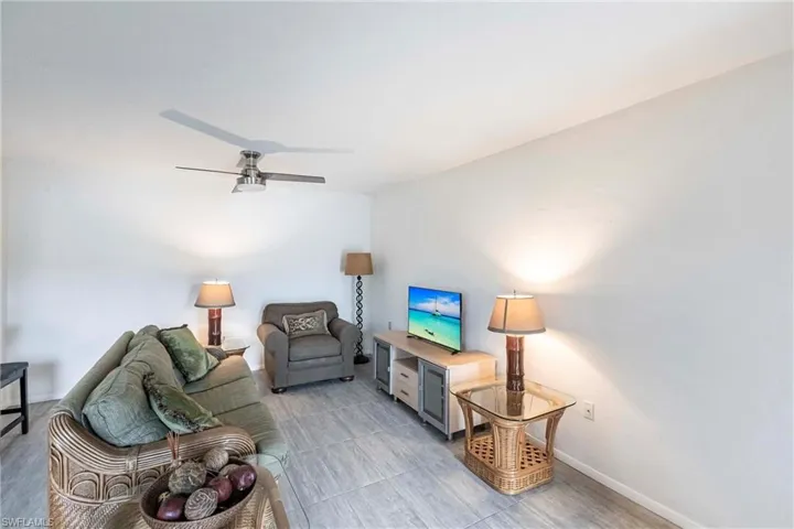 Living room featuring baseboards and ceiling fan