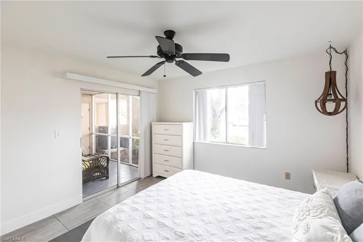 Bedroom with access to outside and a ceiling fan