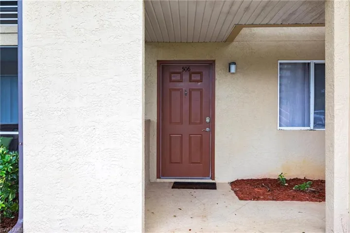 Property entrance featuring stucco siding