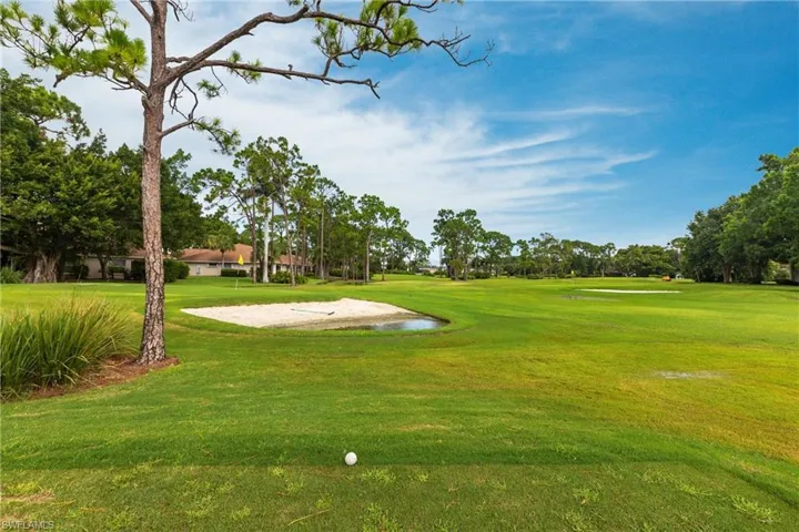 Surrounding community with a lawn and view of golf course