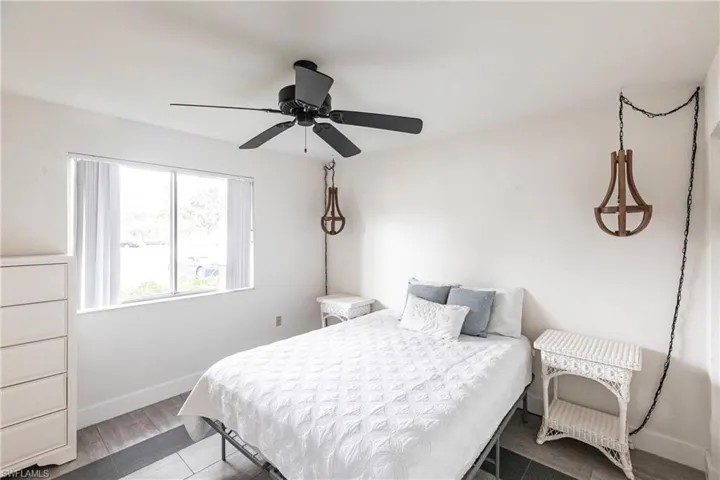 Bedroom with ceiling fan and wood finished floors
