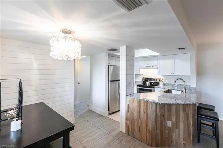 Ship lap walls in Dining Room, beautiful tile flooring throughout, and a brand new kitchen.  Gorgeous!