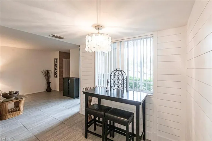 Dining area featuring a chandelier and tile patterned flooring