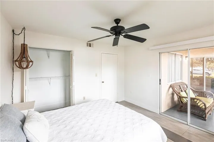 Bedroom with a ceiling fan, a closet, and light wood-style flooring