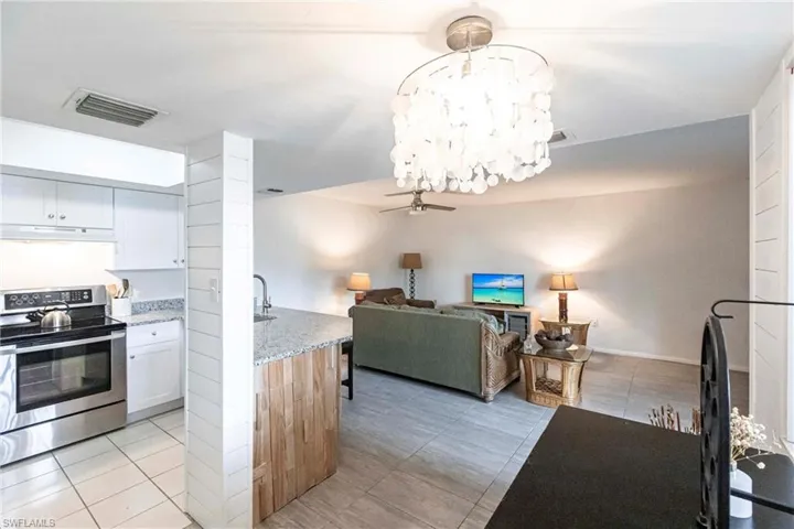 Kitchen overlooks Great Room and light tile patterned floors.