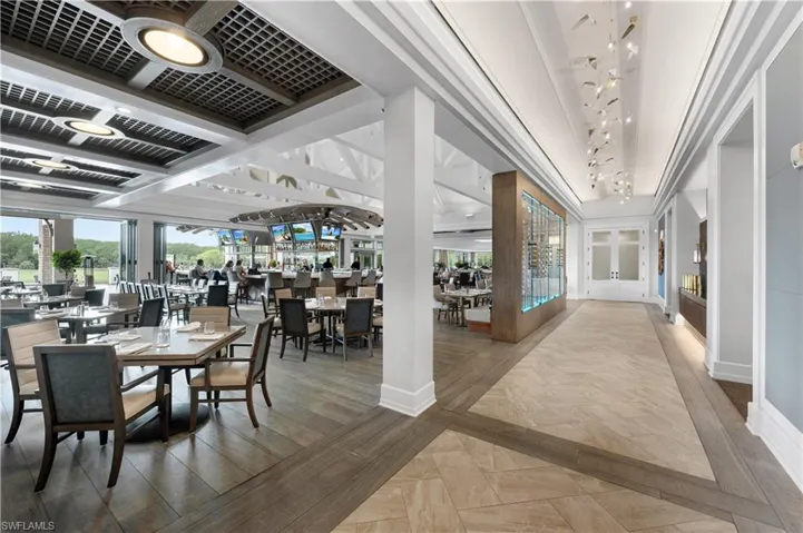Dining room with wood finished floors, inlaid floor details, and plenty of natural light