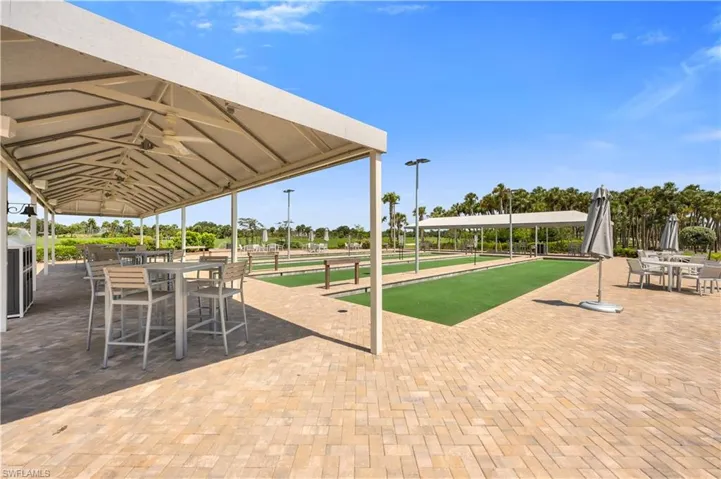 View of home's community with a game area and a patio