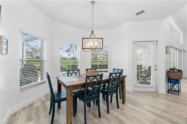 Dining room featuring a notable chandelier and light hardwood / wood-style flooring