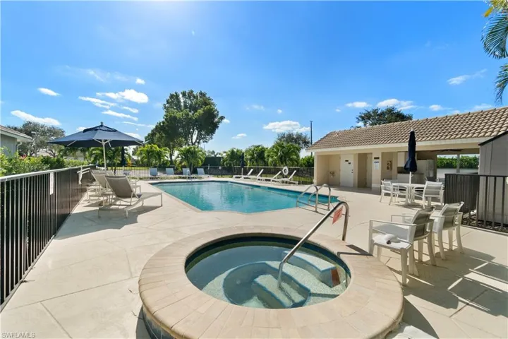 View of pool featuring a community hot tub and a patio