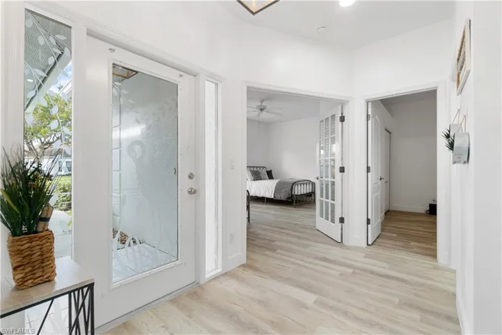 Hallway featuring light hardwood / wood-style flooring and french doors