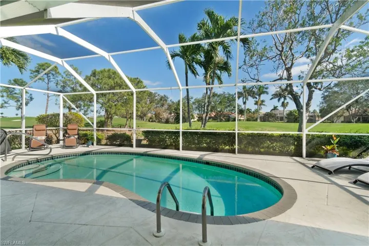 View of swimming pool with a patio and screen enclosure