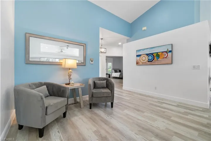 Living area featuring high vaulted ceiling and light hardwood / wood-style floors