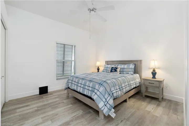 Bedroom with ceiling fan and light hardwood / wood-style floors