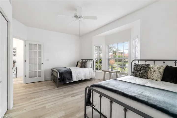 Bedroom with ceiling fan and light hardwood / wood-style flooring