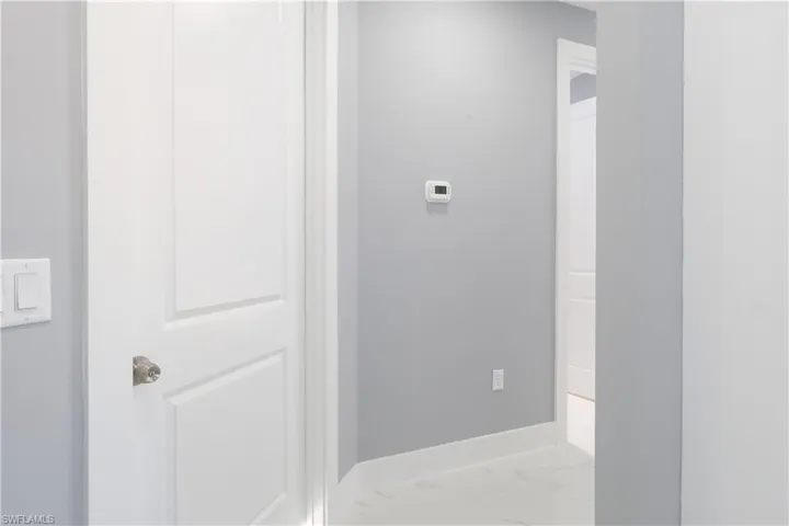 Hall featuring marble finish floors and baseboards
