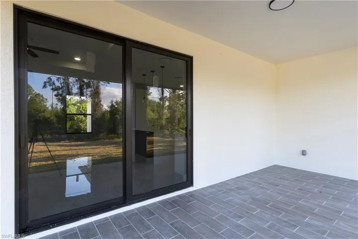 Entrance to property featuring stucco siding