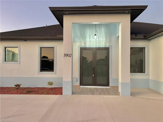 Entrance to property with stucco siding