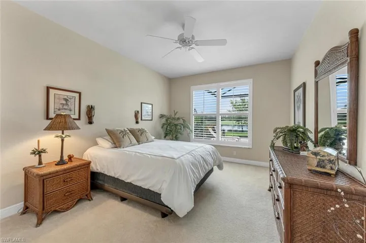 Carpeted bedroom featuring ceiling fan
