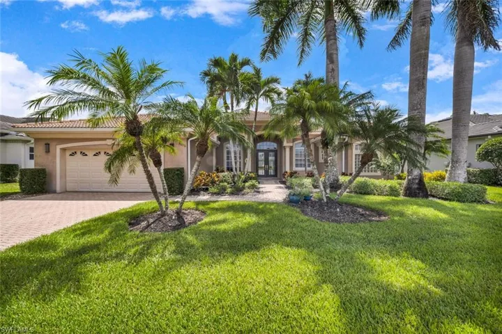 View of front of property with a garage and a front yard