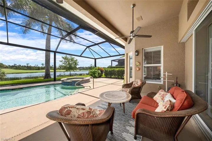View of pool featuring an in ground hot tub, a lanai, a patio area, and ceiling fan