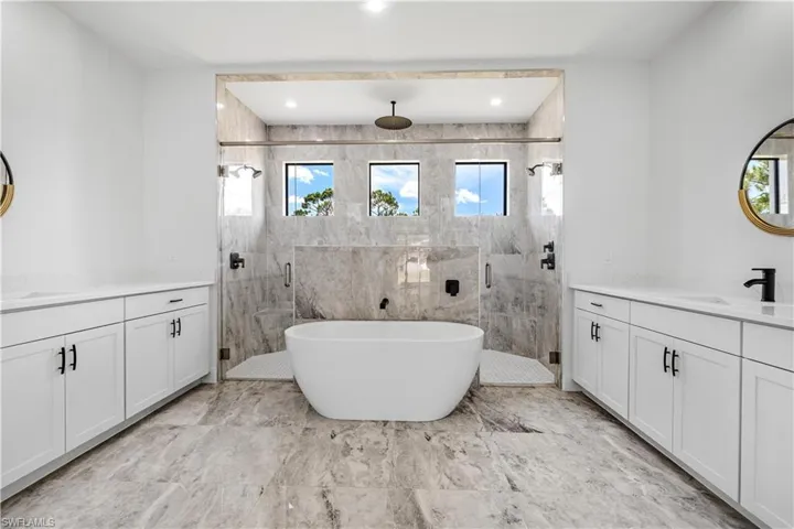 Bathroom with plenty of natural light, vanity, tile patterned flooring, and shower with separate bathtub
