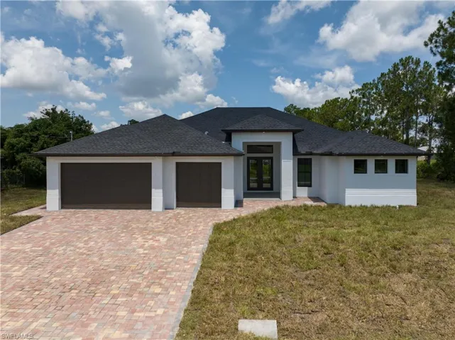 Prairie-style house with a garage and a front yard