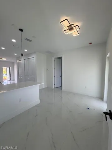 Spare room with light marble finish flooring and recessed lighting