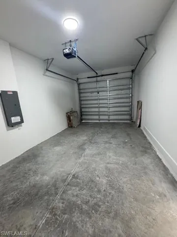 Garage with electric panel and a garage door opener