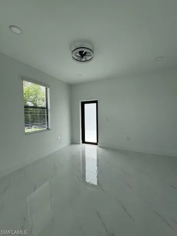 Spare room featuring light marble finish flooring and recessed lighting