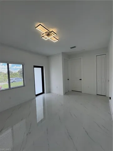 Living room, front door entrance,  featuring light marble finish floors and baseboards, hallway and firth and secund  bed door, guest bath & auxiliar close view.