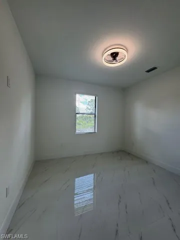 Master bedroom unfurnished room with baseboards and light marble finish flooring