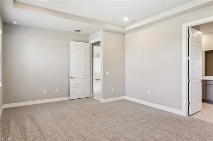Unfurnished bedroom featuring light colored carpet, baseboards, and recessed lighting