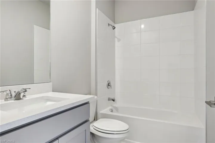 Full bathroom with toilet, shower / bathtub combination, and vanity
