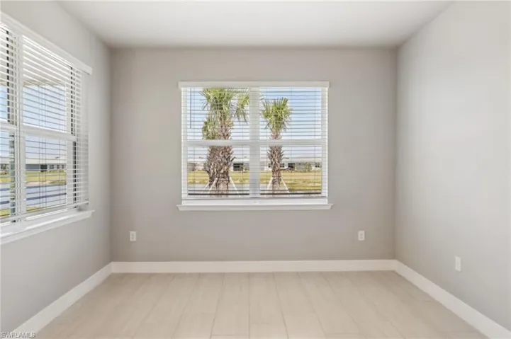Empty room with healthy amount of natural light and baseboards