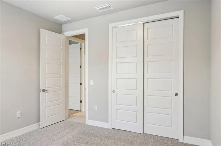 Unfurnished bedroom with carpet flooring, a closet, and baseboards