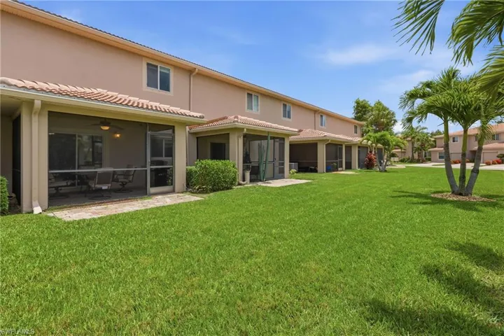 Expansive green lawn bordering residential structures