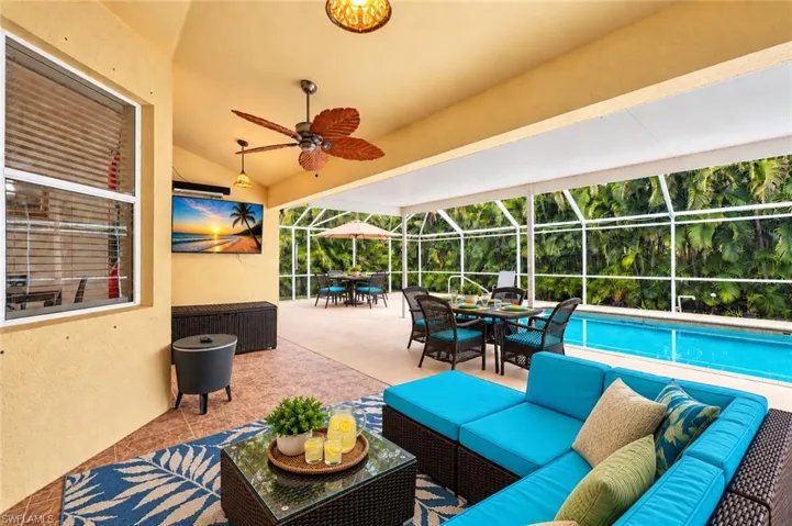 Screened-in patio with tiled flooring, a ceiling fan