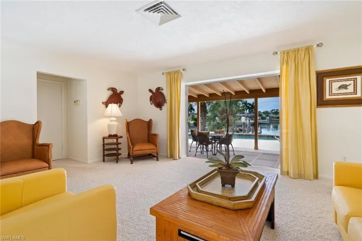 Living area featuring carpet and a sunroom
